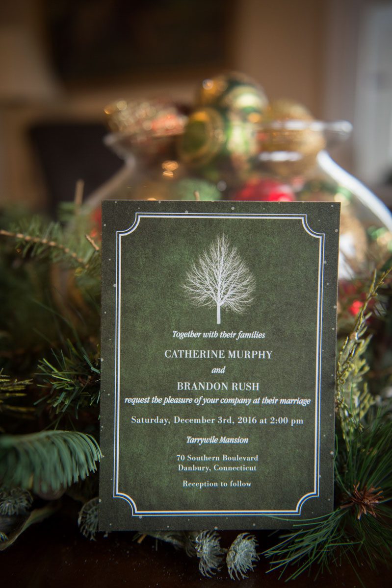 wedding invitation photographed in front of Christmas decorations