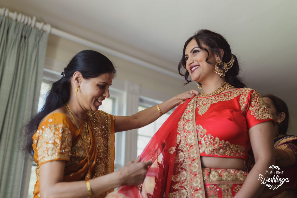 Private Moments mom-helping-bride-with-brightly-colored-indian-reception-attire-danbury-ct