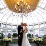 Weddings at Tarrywile couple kissing in conservatory