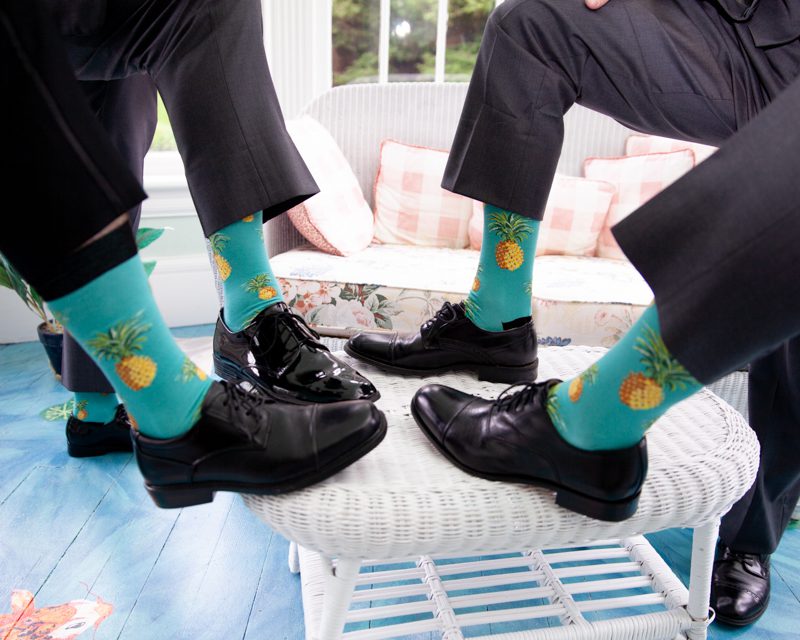 Caribbean Accents cuban-flair-wedding-four-legs-together-showing-off-their-pinapple-themed-socks