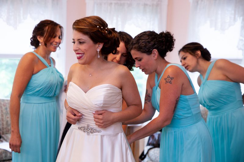 Wedding Day Ready cuban-flair-wedding-Four-bridesmaids-in-aqua-helping-Rachel-into-her-gown