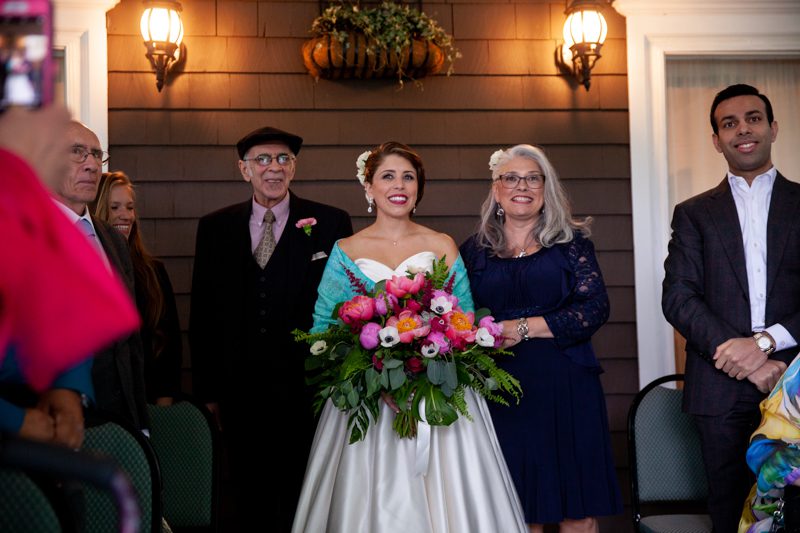 Veranda Wedding Ceremony cuban-flair-wedding-bride-walking-with-her-mom-and-dad-down-the-aisle