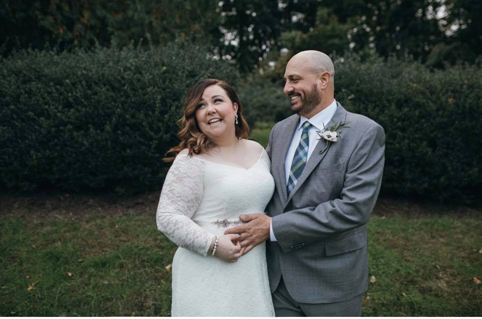couple standing together smiling on back lawn
