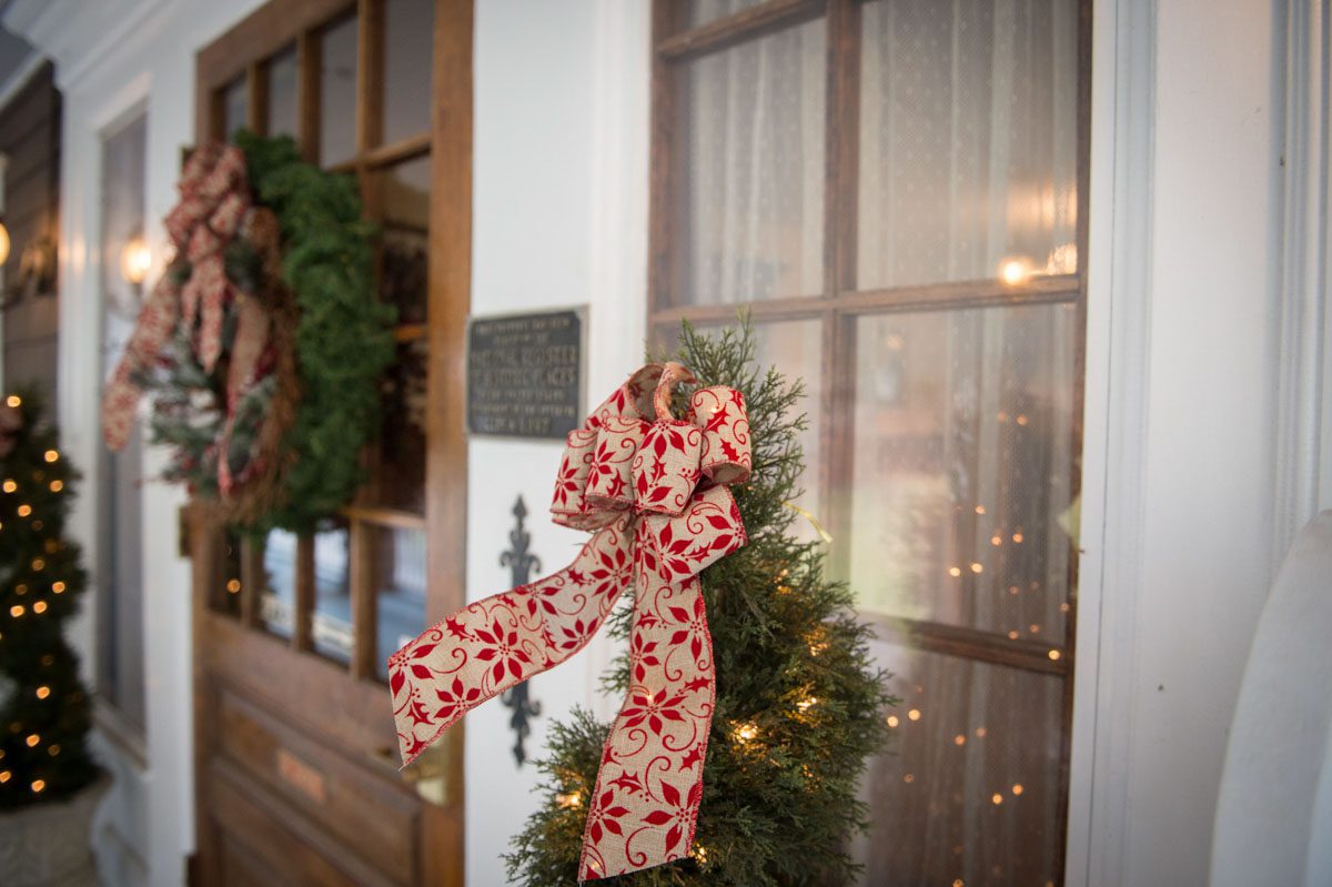 A December Wedding photo of front door with lighted trees