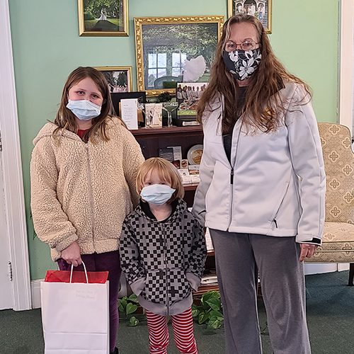 mom and grandchildren holding winning prize