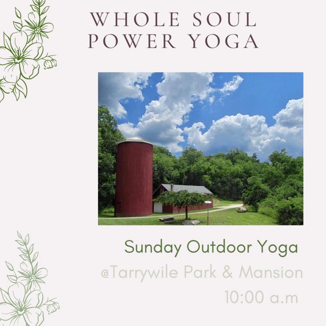 Yoga in the Park red barn in park with cloudy blue sky